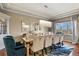 Stylish dining room features a large table, velvet chairs, and modern lighting at 2960 High Prairie Way, Broomfield, CO 80023