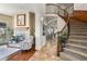 Grand foyer showcasing a curved staircase and a cozy fireplace sitting area at 2960 High Prairie Way, Broomfield, CO 80023
