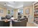 Living room area with a large tv, a desk and built-in bookshelves at 2960 High Prairie Way, Broomfield, CO 80023