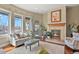 Inviting sitting area with a cozy fireplace, plush seating, and bright windows at 2960 High Prairie Way, Broomfield, CO 80023