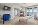 Spacious main bedroom with carpet features a fireplace, tv, private balcony, and serene views at 2960 High Prairie Way, Broomfield, CO 80023