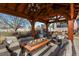 Outdoor seating area with a fire pit and comfortable lounge furniture under a wooden pergola at 2960 High Prairie Way, Broomfield, CO 80023
