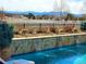 Inviting backyard pool featuring beautiful stone accents and relaxing lounge area at 2960 High Prairie Way, Broomfield, CO 80023