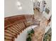 Elegant curved staircase with a dazzling chandelier and stylish tile flooring at 2960 High Prairie Way, Broomfield, CO 80023
