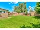 The backyard features sheds, a well-maintained lawn, and a water tower in the distance at 458 Cherry St, Hudson, CO 80642