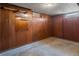Unfinished basement with wood-paneled walls and concrete flooring at 458 Cherry St, Hudson, CO 80642