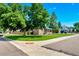 Charming exterior view with green lawn and mature trees enhancing curb appeal at 458 Cherry St, Hudson, CO 80642