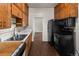 Well-lit kitchen equipped with updated appliances, ample cabinetry, and convenient access to other rooms in the home at 458 Cherry St, Hudson, CO 80642