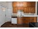 Functional kitchen with wood cabinets, a stainless steel sink, and essential appliances for everyday cooking at 458 Cherry St, Hudson, CO 80642