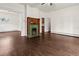 Inviting living room boasts a decorative fireplace with green tile and hardwood floors, creating a cozy atmosphere at 458 Cherry St, Hudson, CO 80642