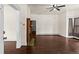 Spacious living room featuring original hardwood floors and a decorative fireplace with green tiling at 458 Cherry St, Hudson, CO 80642