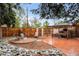 Charming backyard with a pergola, seating area, fire pit, and wood fence offers a relaxing outdoor space at 6625 E 6Th Avenue Pkwy, Denver, CO 80220