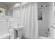 All white bathroom featuring shower-tub combo and pedestal sink at 6625 E 6Th Avenue Pkwy, Denver, CO 80220