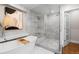 Bright bathroom featuring marble, glass enclosed shower, and luxurious soaking tub at 6625 E 6Th Avenue Pkwy, Denver, CO 80220
