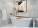 Close up of a marble soaking tub with neutral decor and luxury finishes at 6625 E 6Th Avenue Pkwy, Denver, CO 80220