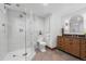 Modern bathroom featuring a glass-enclosed shower and custom wooden vanity at 6625 E 6Th Avenue Pkwy, Denver, CO 80220