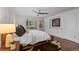 Bright bedroom with hardwood floors, ceiling fan, area rugs, and large built-in storage at 6625 E 6Th Avenue Pkwy, Denver, CO 80220