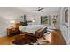 Bright bedroom with hardwood floors, ceiling fan, area rugs, and large windows for natural light at 6625 E 6Th Avenue Pkwy, Denver, CO 80220