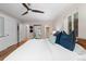 Bedroom with white walls, hardwood floors, ensuite bathroom, and view to hallway at 6625 E 6Th Avenue Pkwy, Denver, CO 80220