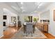 Well-lit dining room with elegant furniture, wood floors, and access to the living area at 6625 E 6Th Avenue Pkwy, Denver, CO 80220