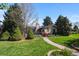 Attractive home featuring a well-maintained lawn, mature trees, and a charming walkway enhances the property's curb appeal at 6625 E 6Th Avenue Pkwy, Denver, CO 80220