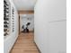 Hallway with wood floors, a wine rack, and access to the fitness area at 6625 E 6Th Avenue Pkwy, Denver, CO 80220