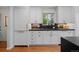 Bright kitchen with white cabinets and black countertops at 6625 E 6Th Avenue Pkwy, Denver, CO 80220