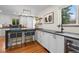 Modern kitchen featuring white cabinets, black countertops, open shelving and built in wine storage at 6625 E 6Th Avenue Pkwy, Denver, CO 80220