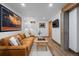 Finished basement with hardwood floors, tan leather couch, and mounted TV at 6625 E 6Th Avenue Pkwy, Denver, CO 80220