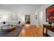 Open-concept living room with wood floors, modern decor, and seamless flow to other spaces at 6625 E 6Th Avenue Pkwy, Denver, CO 80220