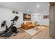 Cozy living room area featuring a comfortable leather sofa and fitness bike at 6625 E 6Th Avenue Pkwy, Denver, CO 80220