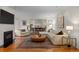 Bright living room with a fireplace, hardwood floors, and an open layout to the dining area at 6625 E 6Th Avenue Pkwy, Denver, CO 80220