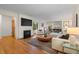 Cozy living room featuring a fireplace, hardwood floors, and seamless access to the dining area at 6625 E 6Th Avenue Pkwy, Denver, CO 80220