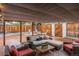 Inviting covered patio with comfortable seating, a fire pit, and a fenced yard create an ideal outdoor retreat at 6625 E 6Th Avenue Pkwy, Denver, CO 80220