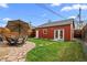 Charming backyard with a patio dining set, green grass, and a shed at 3632 N Marion St, Denver, CO 80205