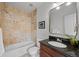 Full bathroom with tiled shower and tub combo, granite countertop vanity, and a decorative mirror at 3632 N Marion St, Denver, CO 80205