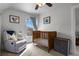 Bright Bedroom with a wooden crib, cozy armchair, and natural light from the window at 3632 N Marion St, Denver, CO 80205
