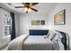 Bedroom with a full-sized bed, a blue dresser, and colorful artwork at 3632 N Marion St, Denver, CO 80205
