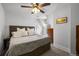 Cozy bedroom with plush carpet, ceiling fan, large bed, and natural light from dormer windows at 3632 N Marion St, Denver, CO 80205