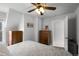 Comfortable bedroom with carpet, ceiling fan, two wooden dressers and natural light from the window at 3632 N Marion St, Denver, CO 80205
