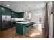 Modern kitchen with hardwood floors, center island with seating, and stainless steel appliances at 3632 N Marion St, Denver, CO 80205