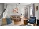 Open concept living room and dining room with stairs, hardwood floors, and plenty of light at 3632 N Marion St, Denver, CO 80205
