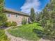 Spacious backyard with lush lawn, mature trees, and a rock border at 16658 Prospect Ln, Broomfield, CO 80023