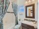 Bathroom with tub, shower curtain, decorative mirror, toilet, and bright natural light at 16658 Prospect Ln, Broomfield, CO 80023