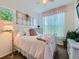 Cozy bedroom with antique window decor, light-colored walls, and natural lighting at 16658 Prospect Ln, Broomfield, CO 80023