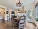 Open dining area with dark hardwood floors, chandelier, and views to the living room at 16658 Prospect Ln, Broomfield, CO 80023