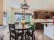 Eat-in kitchen features a rustic chandelier, a wooden table, and dark wood cabinets at 16658 Prospect Ln, Broomfield, CO 80023