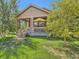 Charming home exterior featuring a inviting front porch and mature landscaping at 16658 Prospect Ln, Broomfield, CO 80023