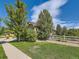 A well maintained lawn is framed by a split rail fence and mature trees at 16658 Prospect Ln, Broomfield, CO 80023