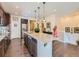 Kitchen island boasts granite countertop, stainless appliances, pendant lighting and hardwood flooring at 16658 Prospect Ln, Broomfield, CO 80023